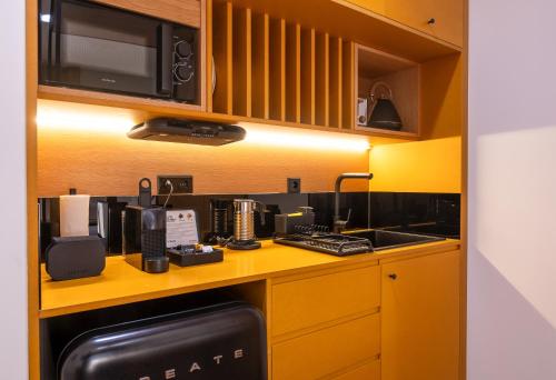 a kitchen with a counter with a coffee maker at BFRESH Hotel - Padel, Pool & Fitness - Adults Only in Porto