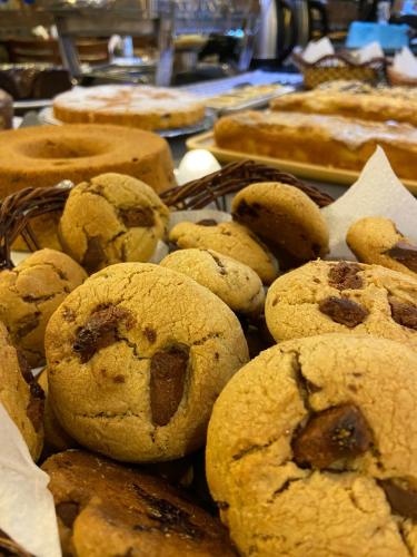 a pile of cookies and pastries on a table at Navega Beach Palace Hotel in Navegantes