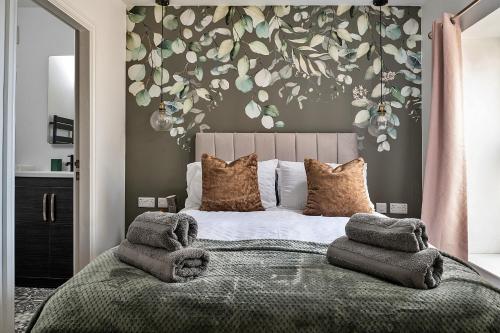 a bedroom with a large bed with pillows on it at Finest Retreats - Peace Retreats in Pwllheli