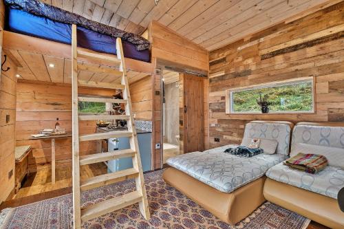 a bedroom with a bunk bed and a couch at Finest Retreats - Cosagach Falls Cabin in Kiltarlty