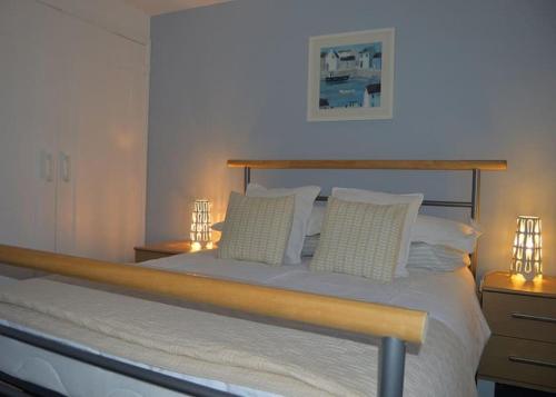 a bedroom with a large bed with two night stands at Old Stone Cottage in Llandysul