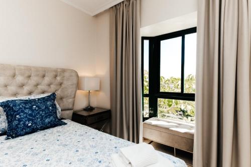 a bedroom with a bed and a window at Capanes de Golf Luxury Apt in Benahavís
