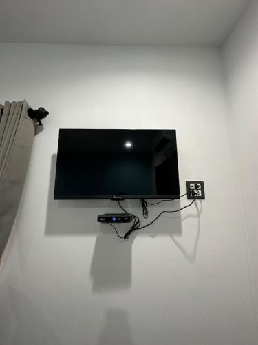 uma televisão de ecrã plano numa parede branca em บ้านชมฟ้า - Bann Chomfah Resort & Cafe 