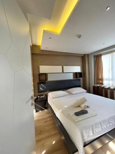 a bedroom with a large bed with white sheets at The Sisli Luxury Corner Suit in Istanbul
