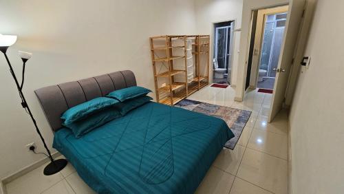 a bedroom with a bed with blue pillows on it at Serenestay Cozy Studio @ Southville City in Kajang