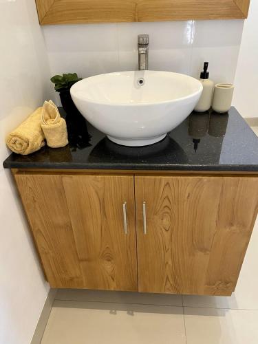 a bathroom sink with a white bowl on a counter at Villa Solas Legian in Legian