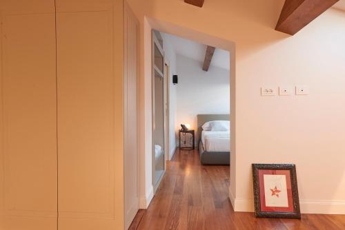 a bedroom with a bed and a picture in a frame at Relais - Palazzo Greco Stella in Lamezia Terme