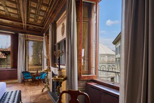 Cette chambre dispose d'une grande fenêtre offrant une vue sur un bâtiment. dans l'établissement Duomo Luxury Florence, à Florence