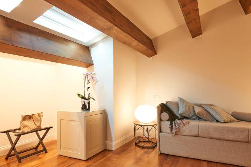 a living room with a couch and a skylight at Relais - Palazzo Greco Stella in Lamezia Terme