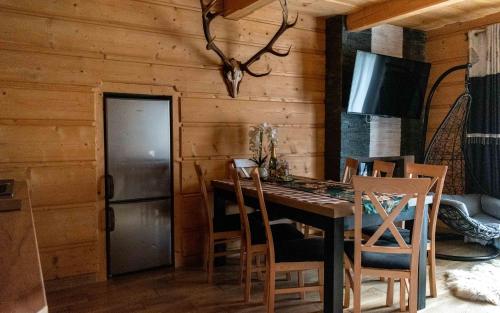 a dining room with a table and chairs at Domki Dream House Resort 606-436-626 in Poronin