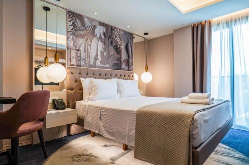 a bedroom with a bed and a desk and a chair at Gate Twenty Two Boutique Hotel in Nicosia