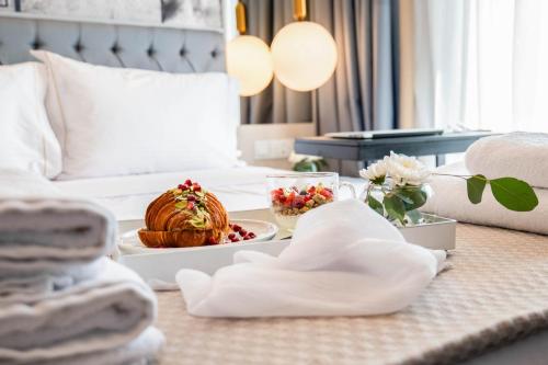 a hotel room with a tray of food on a bed at Gate Twenty Two Boutique Hotel in Nicosia