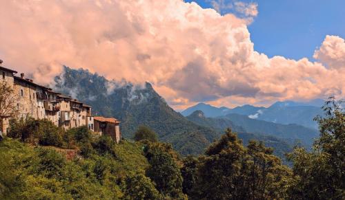 a view of a mountain with houses and trees at B&B Piccolo Tibet in Lavenone