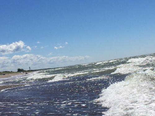 a wave in the ocean on a beach at Pape Rogas in Pape