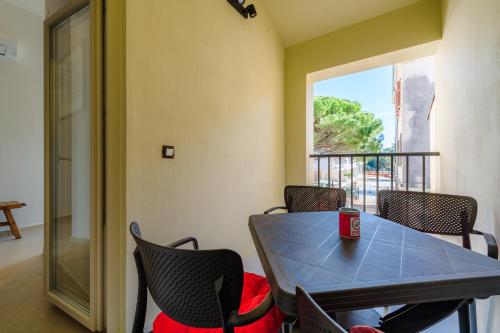 a table and chairs in a room with a window at Apartments Urban in Poreč