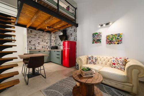 a living room with a couch and a red refrigerator at Apartments Urban in Poreč