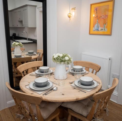 a wooden table with chairs and a dining room at Bridge View in Annan