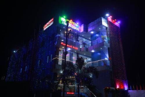 a building lit up with christmas lights at night at Hotel The Heaven in Muzaffarpur