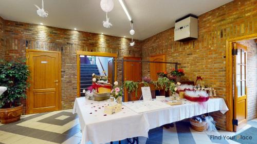 a room with a table in a brick wall at Hotel IL Castellino in Chaudfontaine