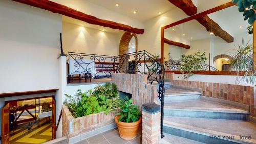 a house with a staircase and a lobby at Hotel IL Castellino in Chaudfontaine