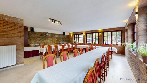 a large dining room with a long table and chairs at Hotel IL Castellino in Chaudfontaine
