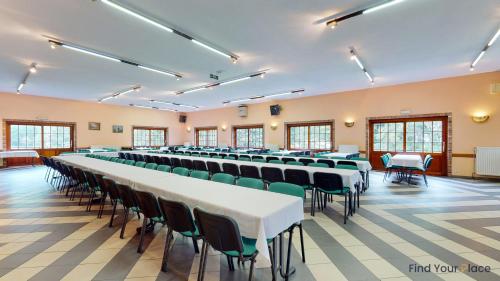 a large room with rows of tables and chairs at Hotel IL Castellino in Chaudfontaine