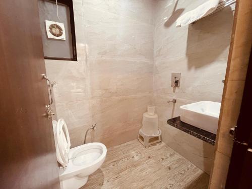 a bathroom with a toilet and a sink at The Divine Ganga - Top Rated and Most Awarded Property In Haridwar in Haridwār