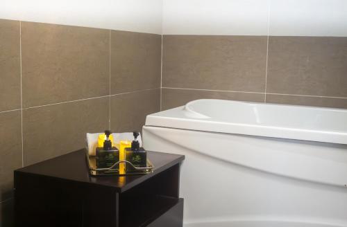 a bathroom with a toilet and a sink and a tub at Sunview Beach Hotel Danang in Da Nang