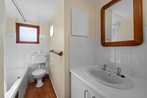 a bathroom with a sink and a toilet and a mirror at San Lameer Villa 2015 - 3 Bedroom Standard - 6 pax - San Lameer Rental Agency in Southbroom