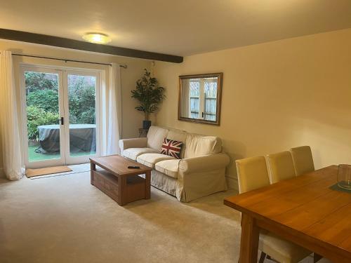 a living room with a couch and a table at The Old Coach House in Stratford-upon-Avon