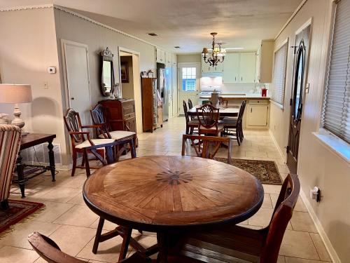 a kitchen and dining room with a wooden table and chairs at Birmingham House - Updated and Spacious in Llano