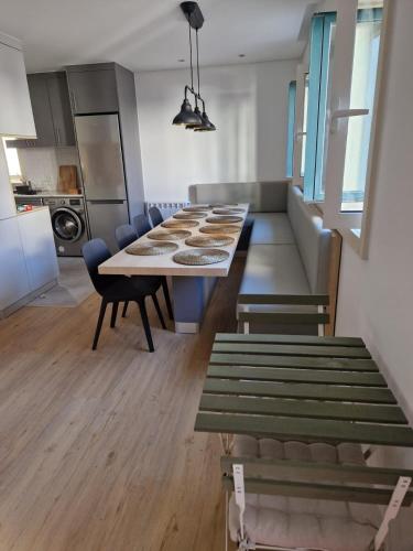 a kitchen and dining room with a table and chairs at TuKaza by Geyra - Fão in Esposende