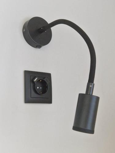 a black light on a wall with a socket at TuKaza by Geyra - Fão in Esposende