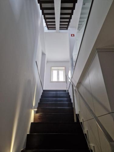 a staircase in a building with a window at TuKaza by Geyra - Fão in Esposende