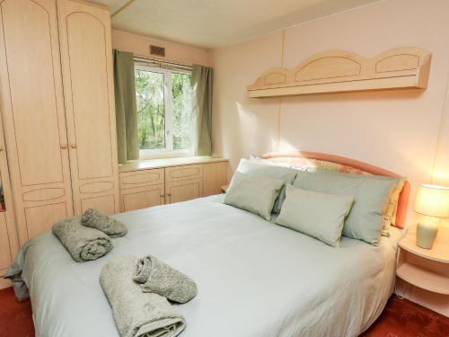 a bedroom with a white bed with towels on it at Chill Out Holiday in Pencader