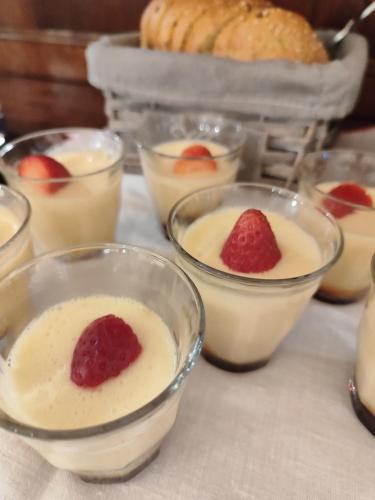 a table topped with bowls of dessert with a strawberry in it at Casa Lumaca in Tremezzo