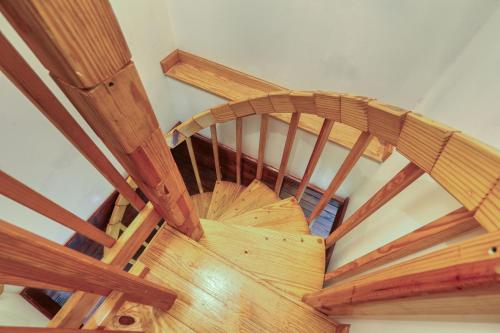 an overhead view of a wooden spiral staircase at Into the Wild Cabin in Cosby