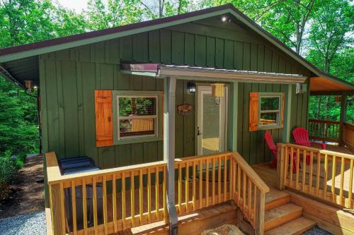 a green tiny house with a porch and chairs at Beside Still Water 2 - 2 Bedrooms, 2 Baths, Sleeps 6 home in Cosby