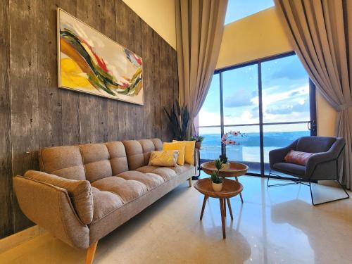 a living room with a couch and a table at Loft Suite Seaview JB CIQ 7Pax in Johor Bahru