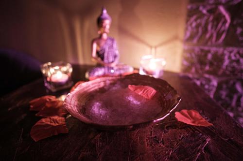 a glass bowl sitting on a table with candles at Maison Chanely in Calcata