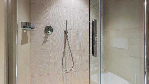 a bathroom with a shower with a glass door at VILLA BOEMIA 10, Emma Villas in Alessandria
