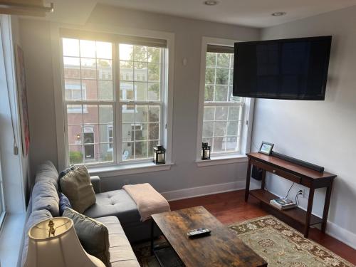a living room with a couch and a table at Sun-filled Capitol Hill home w/ parking & roofdeck in Washington, D.C.