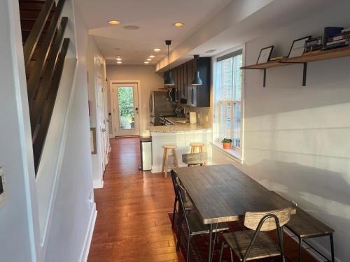 a kitchen and dining room with a wooden table at Sun-filled Capitol Hill home w/ parking & roofdeck in Washington, D.C.