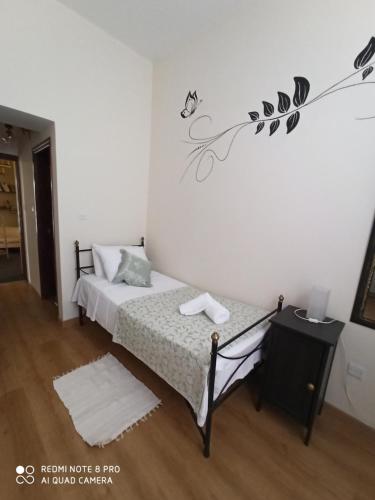 a bedroom with a bed and a wall with a flower mural at Lefkara Hotel in Pano Lefkara