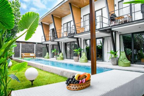 an exterior view of a villa with a swimming pool at KAMMARA LOFT - Bali Invest Club in Canggu