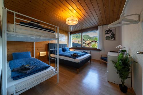 a bedroom with two bunk beds and a window at Alpenblick mit Balkon nahe Interlaken in Wilderswil