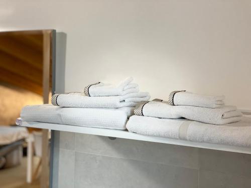 a stack of towels on a shelf in a room at Il Ciliegio Relax & Wellness in Druento