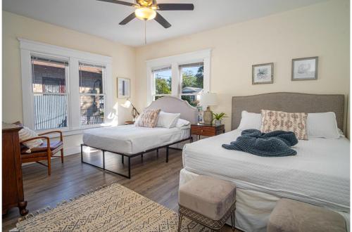 a bedroom with two beds and a couch and a fan at Brand New Craftsman 2BR2BA Home in Denver Heights in San Antonio
