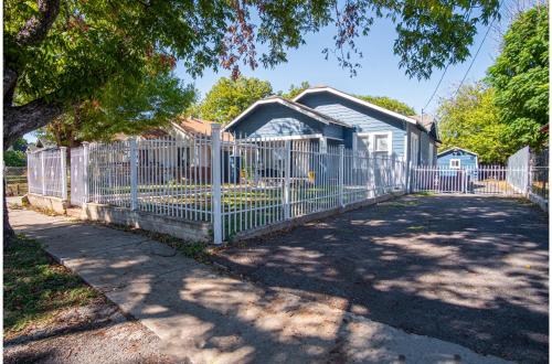 a white fence in front of a house at Brand New Craftsman 2BR2BA Home in Denver Heights in San Antonio