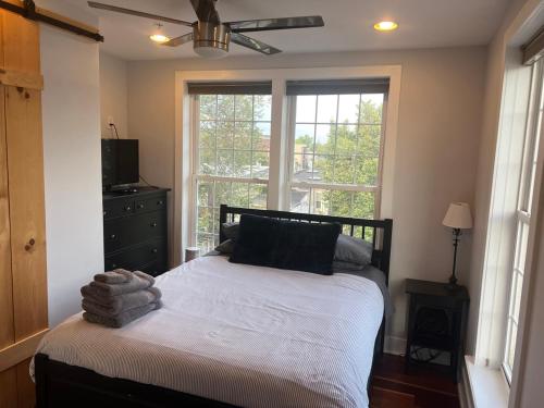 a bedroom with a bed in front of a window at Sun-filled Capitol Hill home w/ parking & roofdeck in Washington